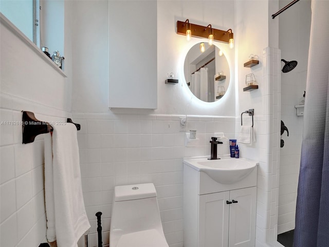 full bath with vanity, wainscoting, curtained shower, tile walls, and toilet