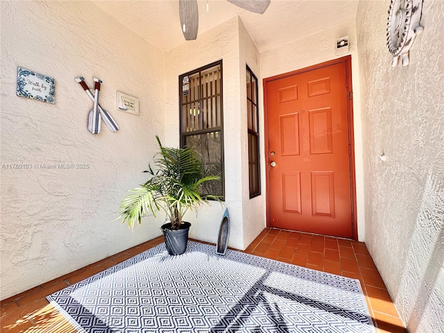 doorway to property featuring stucco siding