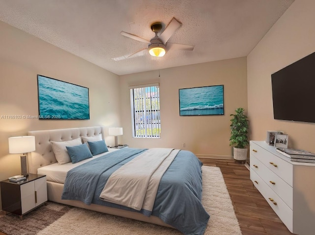 bedroom featuring baseboards, a textured ceiling, a ceiling fan, and wood finished floors