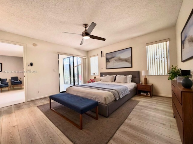 bedroom with a ceiling fan, baseboards, a textured ceiling, access to outside, and light wood-type flooring