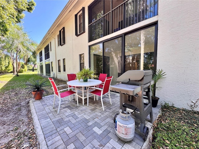 view of patio featuring outdoor dining space and a grill