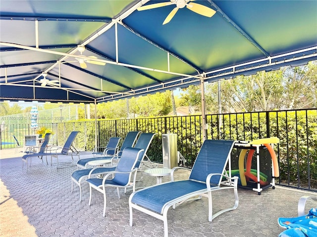 view of patio / terrace with a ceiling fan and fence