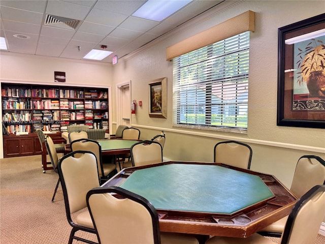 interior space featuring a paneled ceiling, visible vents, and ornamental molding