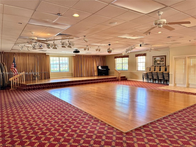 miscellaneous room featuring wood finished floors, baseboards, visible vents, ceiling fan, and a paneled ceiling