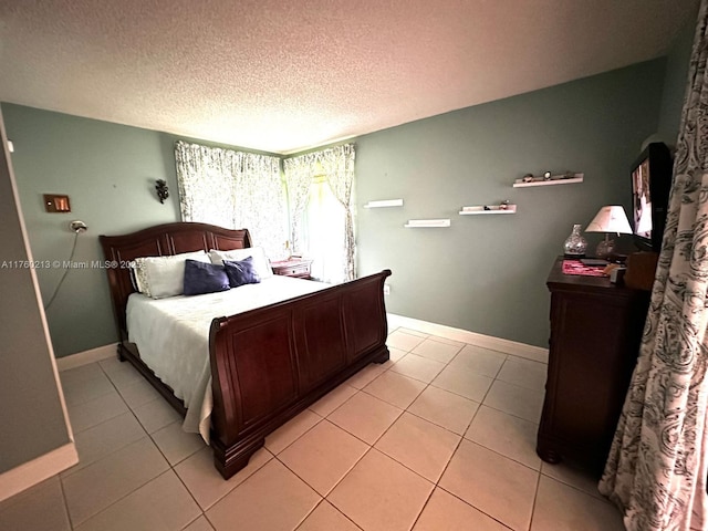 9015 SW 125th Ave Unit N109, Miami, FL 33186 - bedroom with baseboards, a textured ceiling, and light tile patterned floors