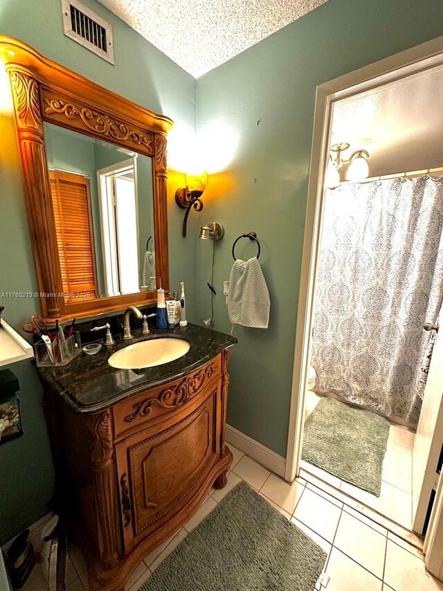9015 SW 125th Ave Unit N109, Miami, FL 33186 - full bathroom featuring vanity, tile patterned flooring, visible vents, toilet, and baseboards