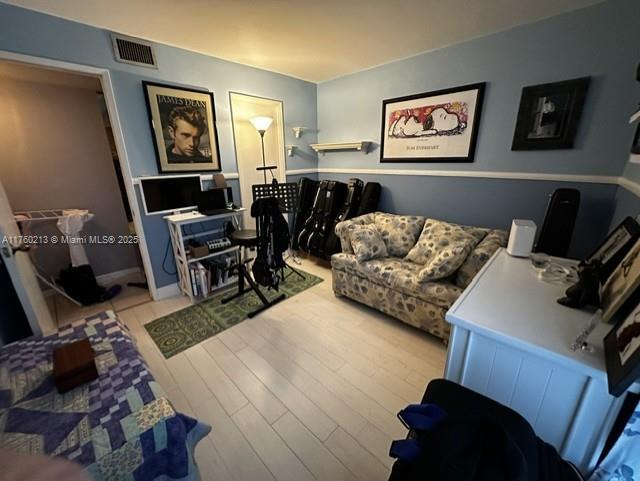 living room featuring visible vents and light wood-style floors