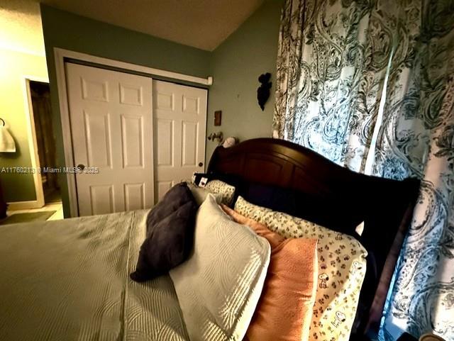 bedroom featuring a closet and vaulted ceiling