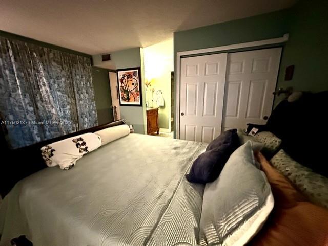 bedroom featuring a closet and visible vents