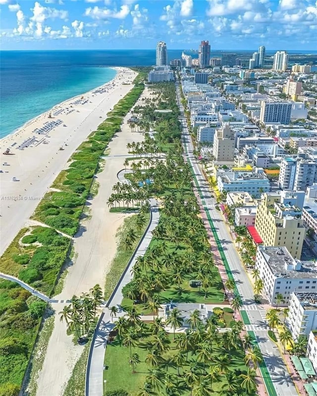 bird's eye view featuring a water view, a view of city, and a view of the beach