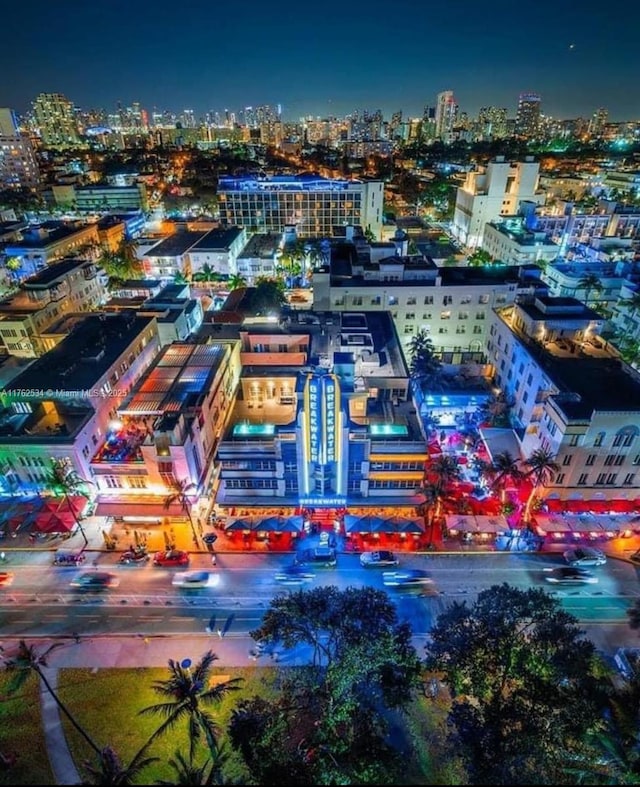 aerial view at night featuring a view of city lights