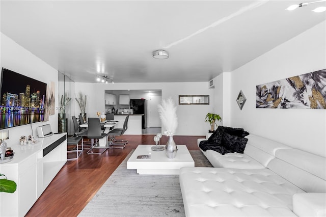 living area with visible vents and dark wood-style flooring