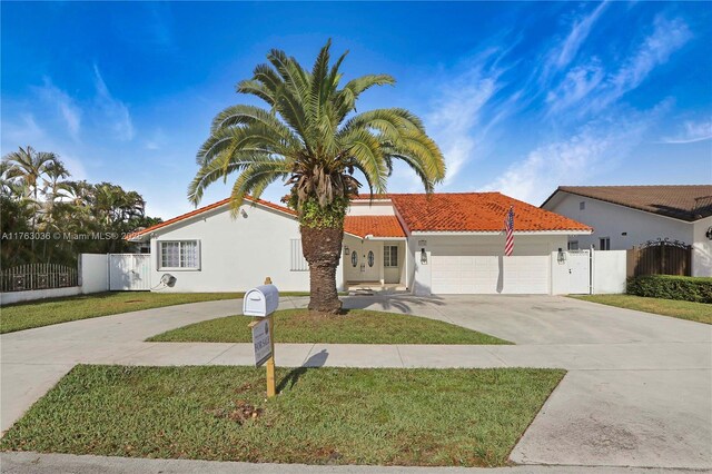 116 SW 135th Ave, Miami, FL 33184 - view of front of house featuring a tiled roof, stucco siding, driveway, and a garage