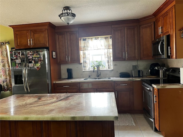 kitchen featuring light countertops, appliances with stainless steel finishes, and a sink