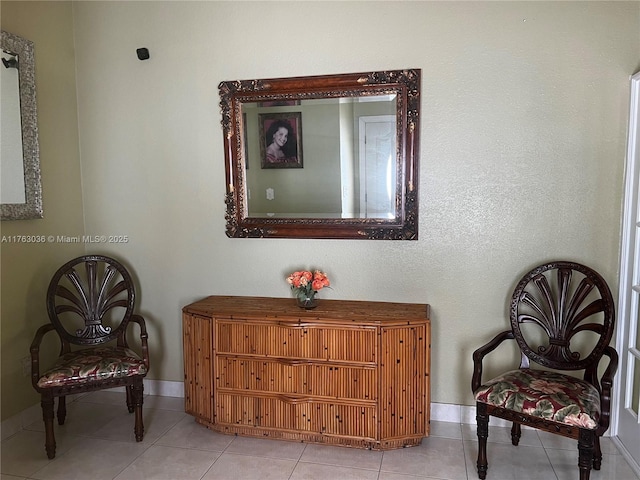 sitting room with tile patterned floors and baseboards