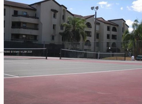 view of tennis court with fence