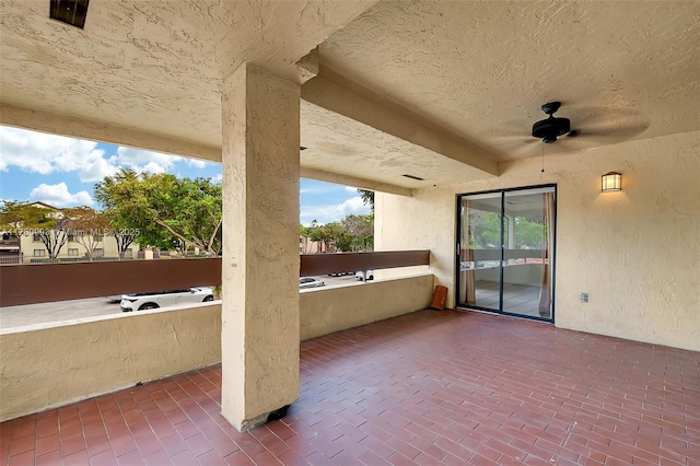 view of patio with a balcony and a ceiling fan