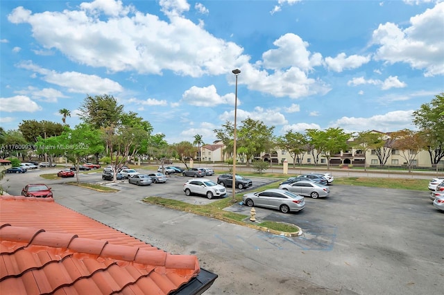 uncovered parking lot with a residential view