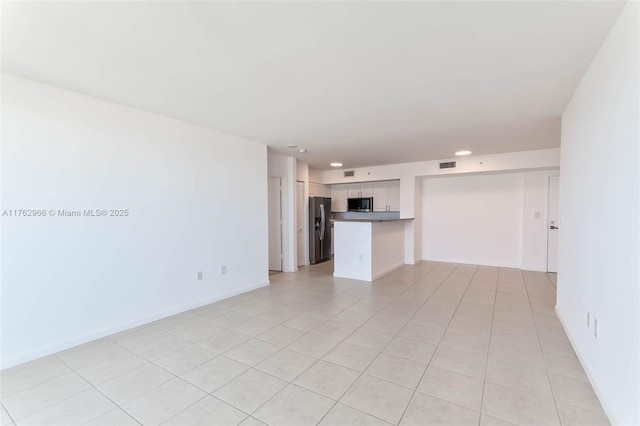 unfurnished living room with light tile patterned flooring, visible vents, recessed lighting, and baseboards