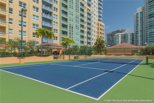 view of tennis court featuring fence