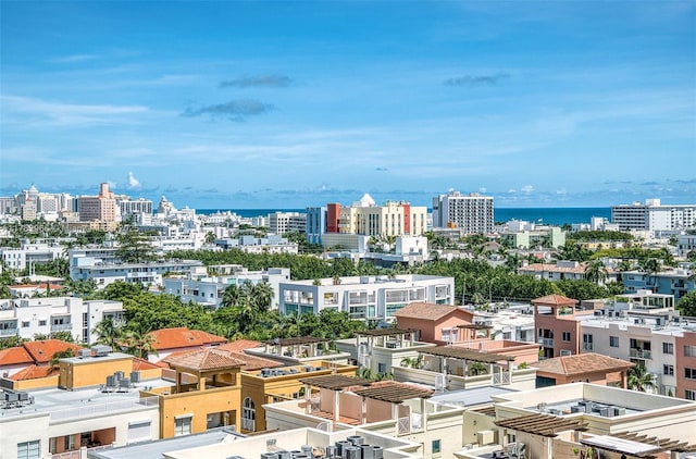 birds eye view of property with a city view and a water view