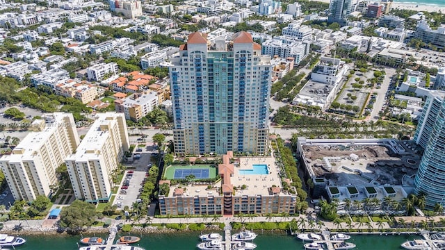 drone / aerial view featuring a city view and a water view