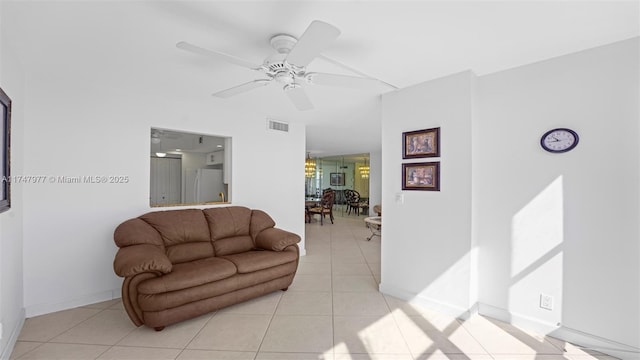 living room with light tile patterned floors, baseboards, visible vents, and ceiling fan