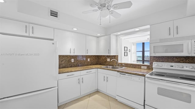 kitchen featuring visible vents, decorative backsplash, white cabinets, white appliances, and a sink