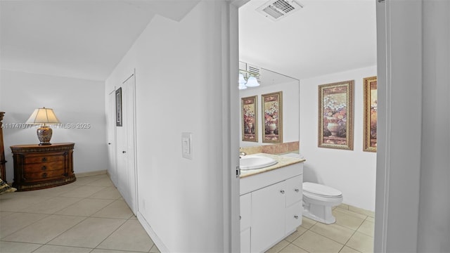 bathroom featuring visible vents, toilet, vanity, and tile patterned flooring