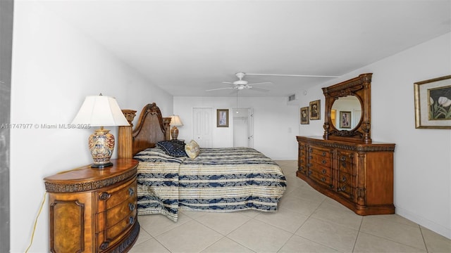 bedroom featuring light tile patterned floors, a closet, and ceiling fan