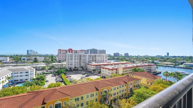 drone / aerial view featuring a city view and a water view