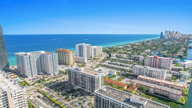 birds eye view of property with a water view and a view of city