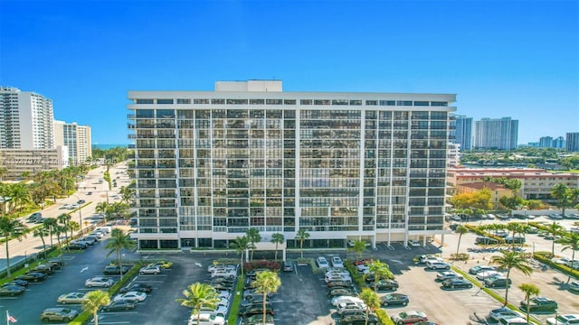 view of property with a view of city and uncovered parking