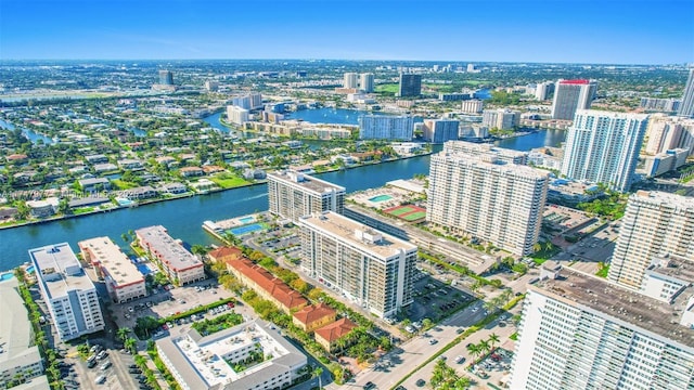 birds eye view of property with a water view and a view of city