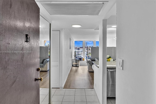 corridor featuring light tile patterned floors and visible vents