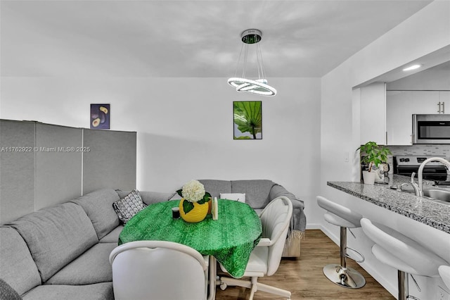 dining space featuring baseboards and wood finished floors