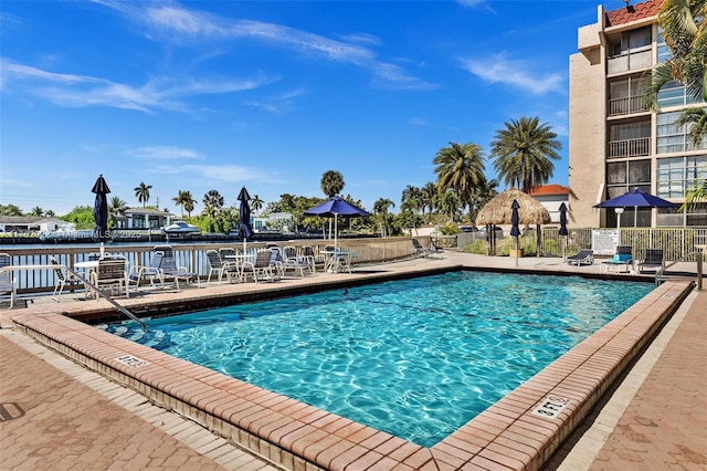 community pool featuring a patio area and fence