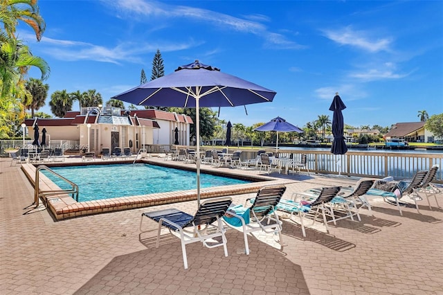 pool with a patio and fence