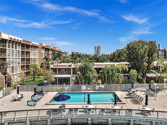 community pool featuring a patio area and fence