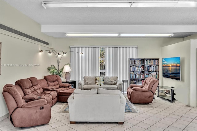 living room featuring light tile patterned floors and a textured ceiling