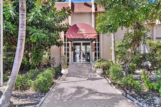 entrance to property with french doors and stucco siding