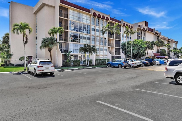 view of building exterior featuring uncovered parking