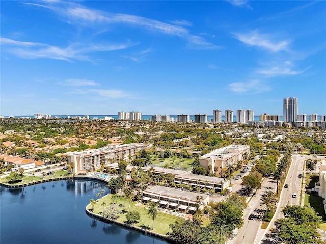 drone / aerial view featuring a view of city and a water view