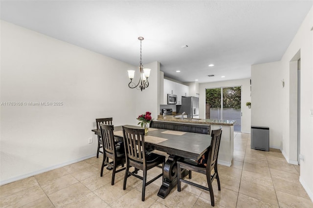 dining area featuring light tile patterned flooring, a notable chandelier, recessed lighting, and baseboards