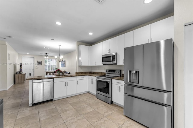 kitchen with a sink, stainless steel appliances, recessed lighting, and white cabinetry