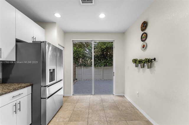 kitchen featuring visible vents, recessed lighting, white cabinets, stainless steel fridge with ice dispenser, and baseboards