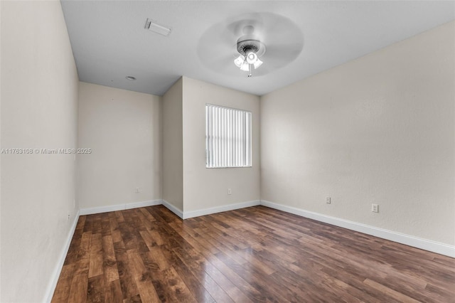 spare room with visible vents, baseboards, ceiling fan, and wood finished floors