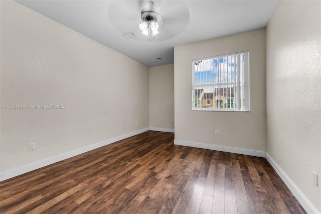 spare room featuring ceiling fan, baseboards, and wood-type flooring