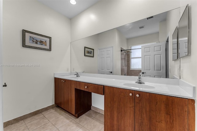 full bath with visible vents, double vanity, a sink, tile patterned flooring, and walk in shower