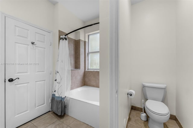 bathroom with tile patterned floors, toilet, baseboards, and shower / bathtub combination with curtain